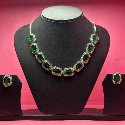 Jewelry set with necklace and earrings on a black mannequin against a pink background