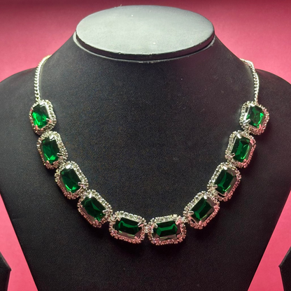 Jewelry set with necklace and earrings on a black mannequin against a pink background